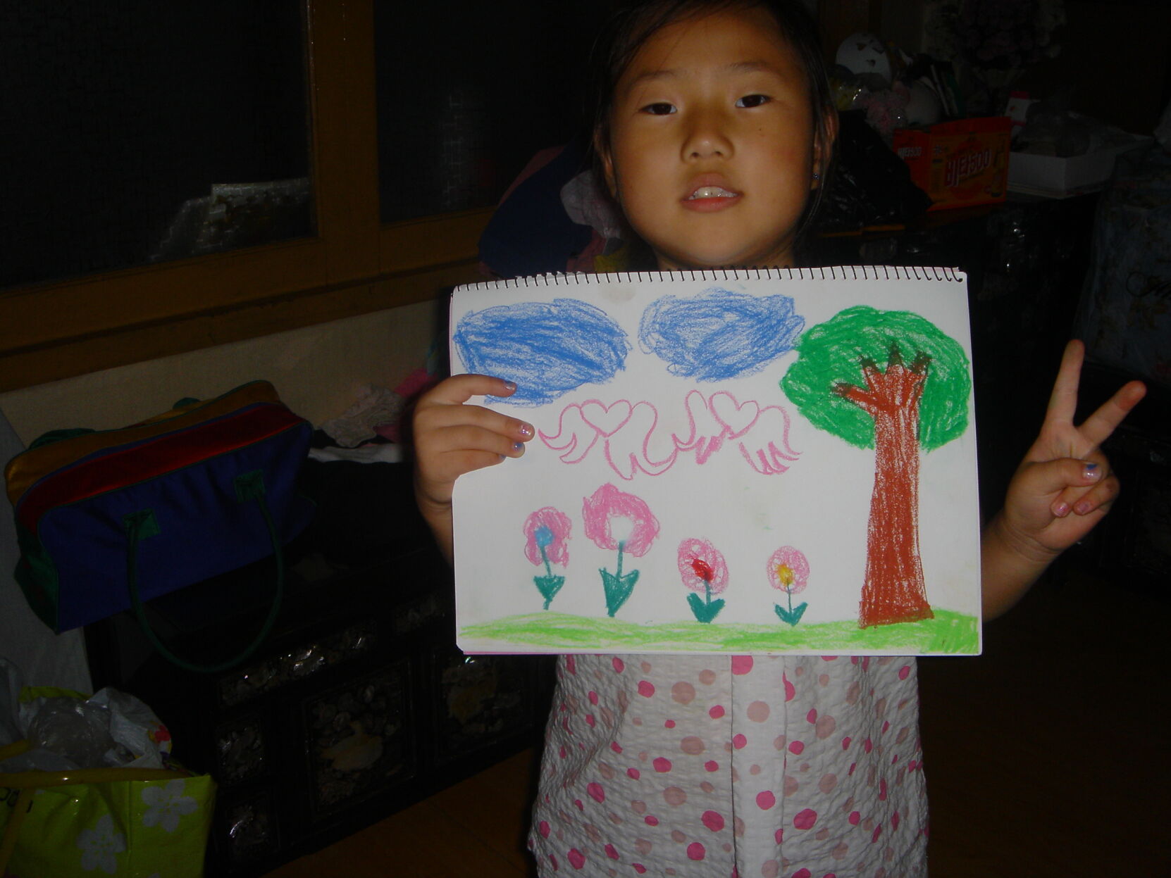 Kim holding drawing